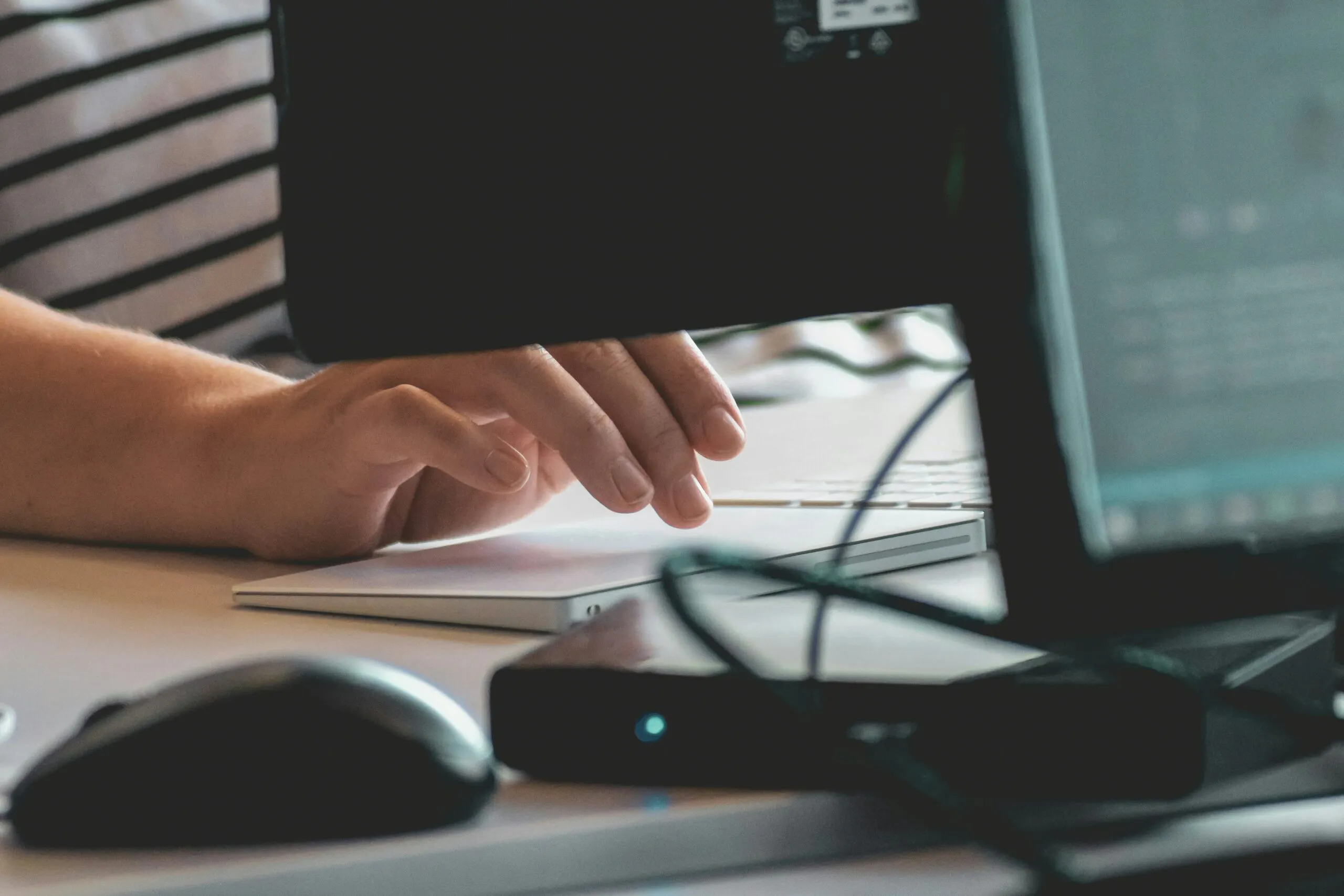 A person typing on a keyboard while taking a CAT Exam

