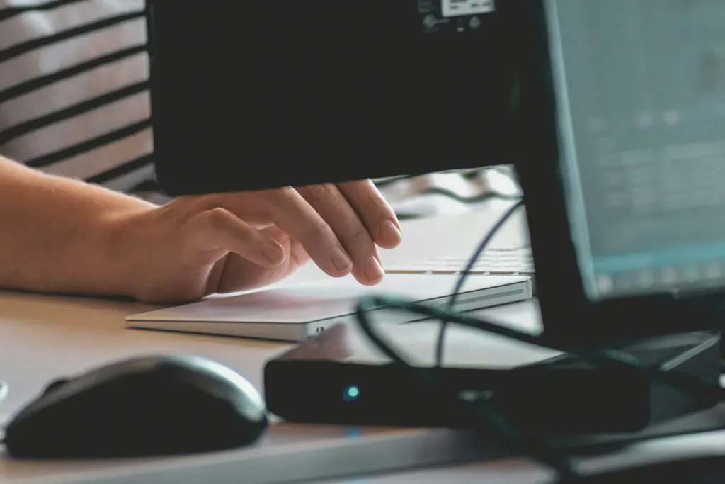 A person typing on a keyboard while taking a CAT Exam