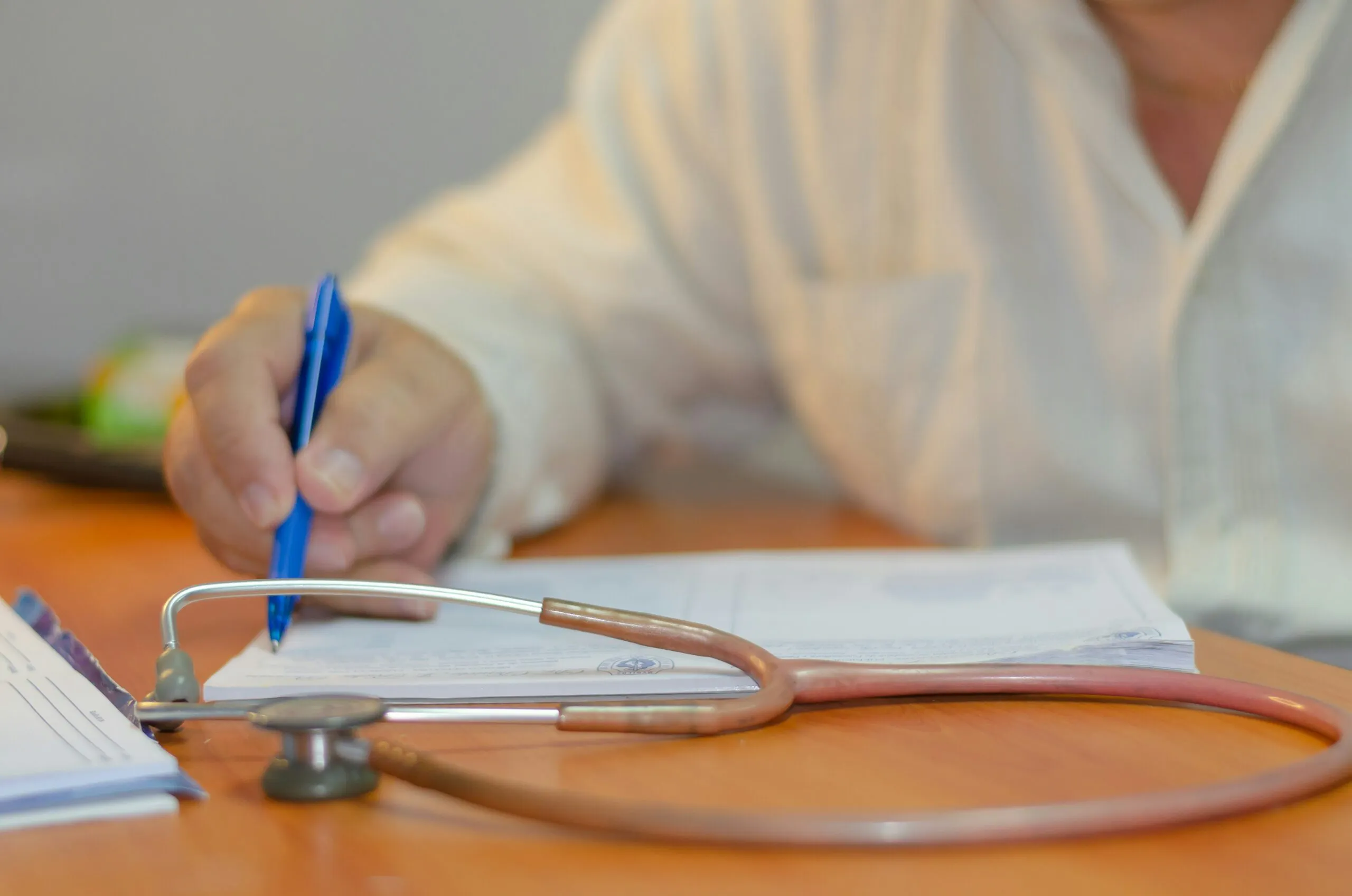 A person taking notes to study for their NCLEX Cat Exam