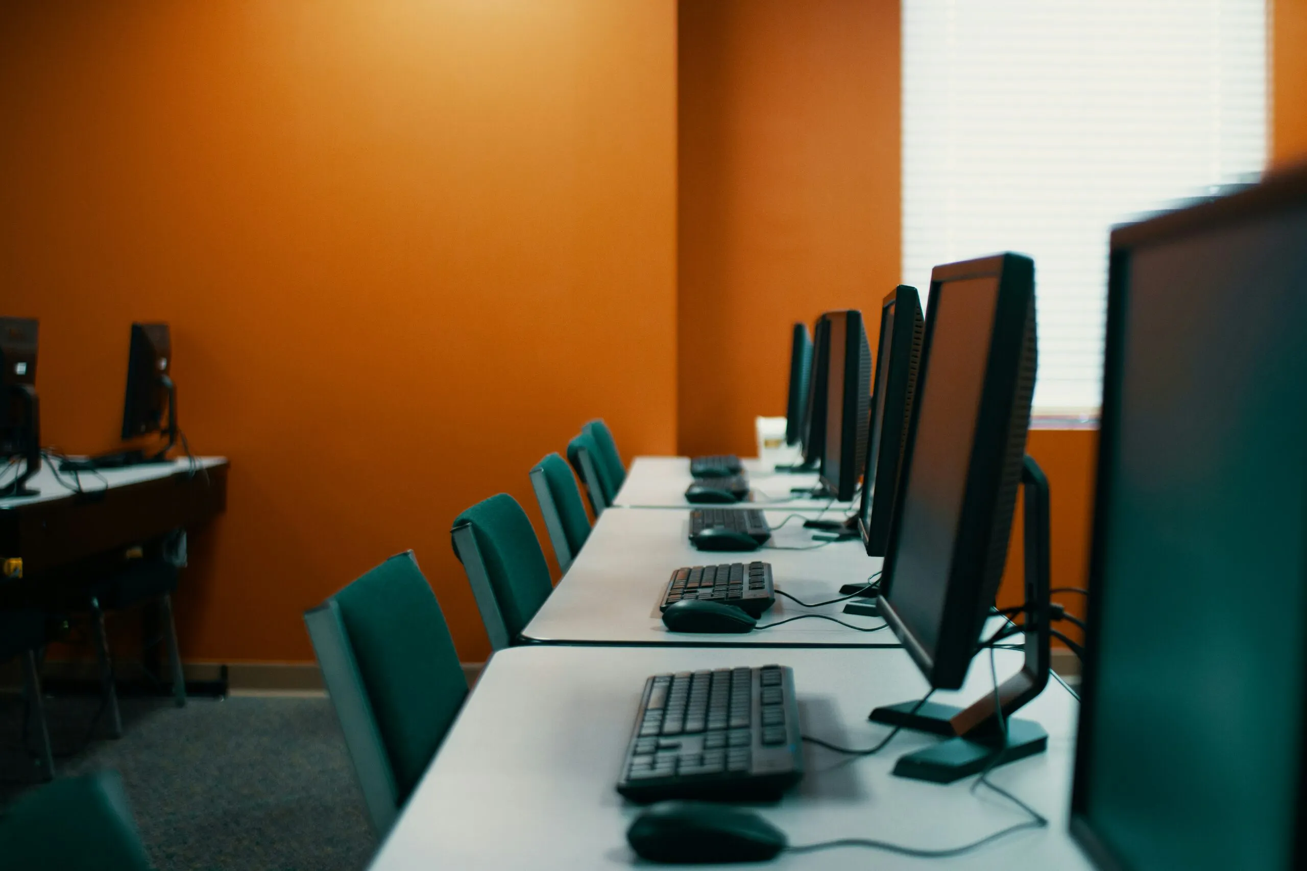 A row of computers in a practice NCLEX Cat testing facility