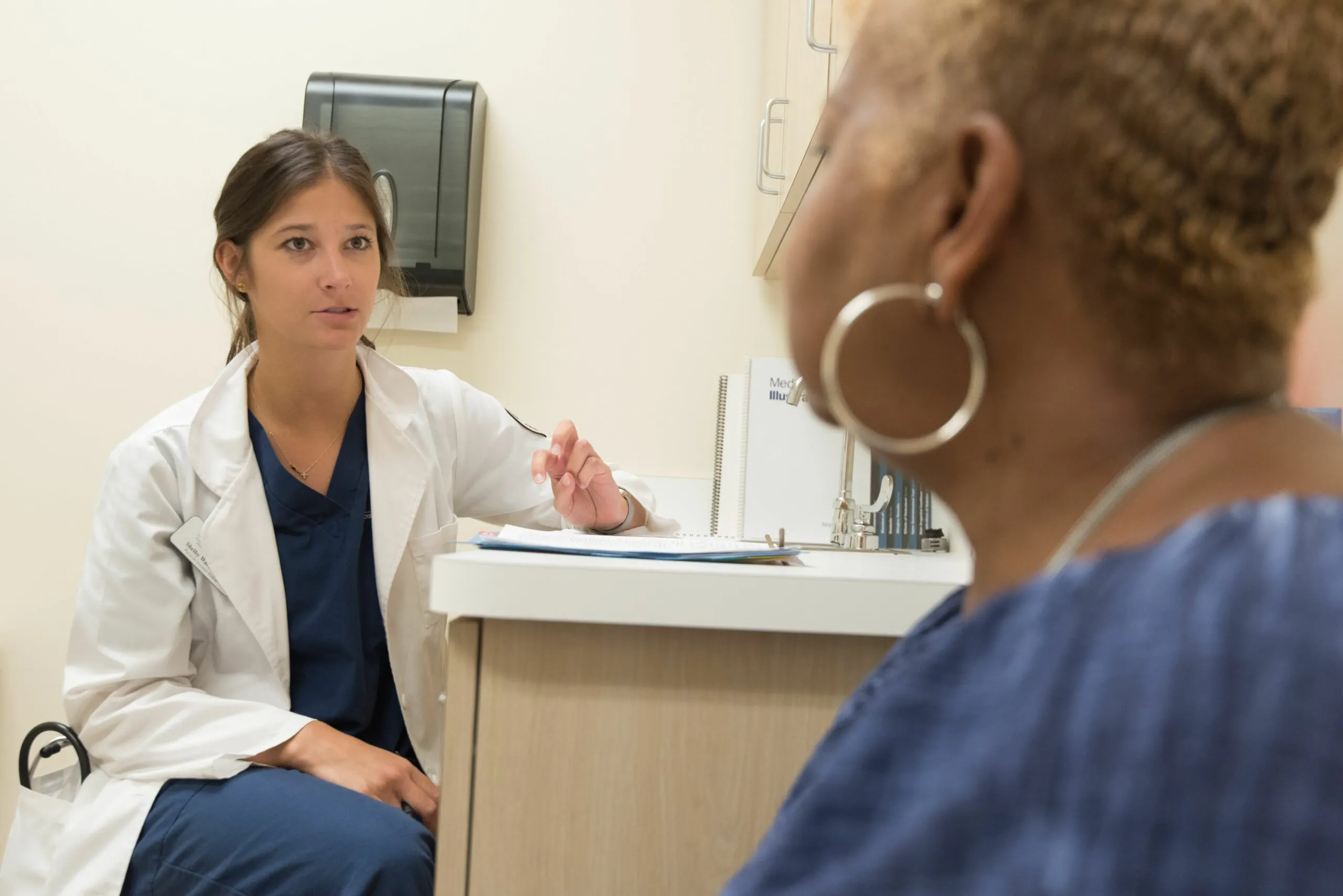 Family nurse practitioner discussing care with a patient in a clinic