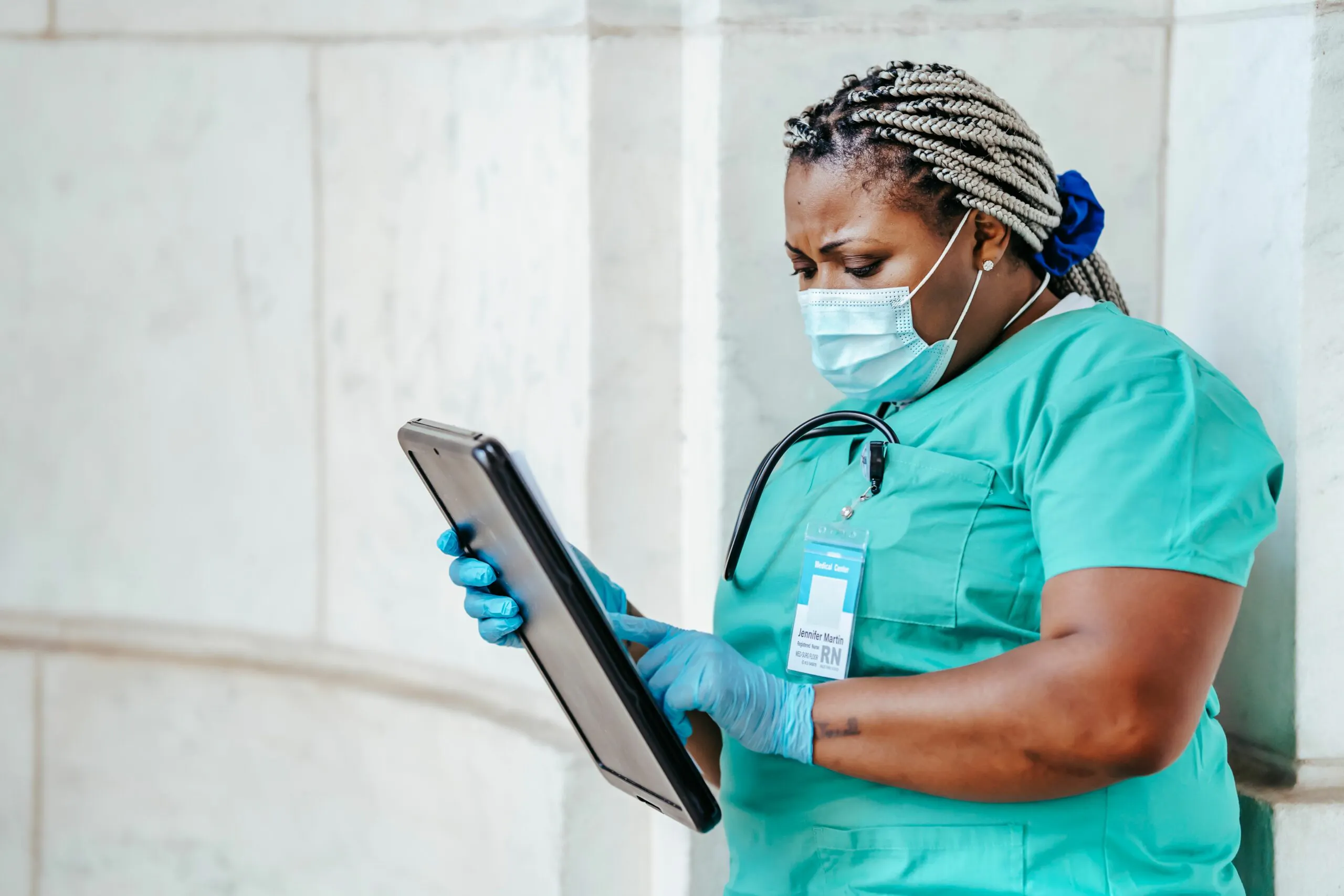 Healthcare worker reviewing patient information on a tablet