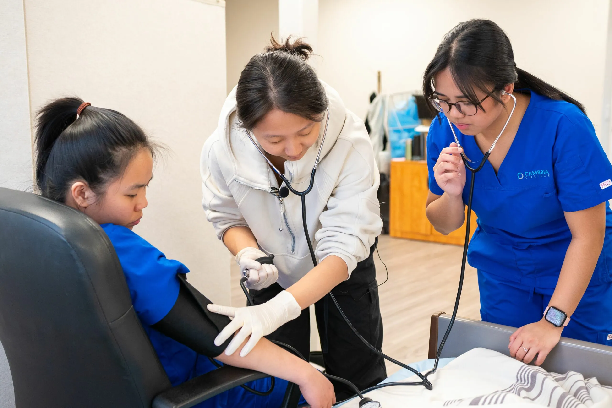 Nursing students practicing blood pressure measurement during clinical training