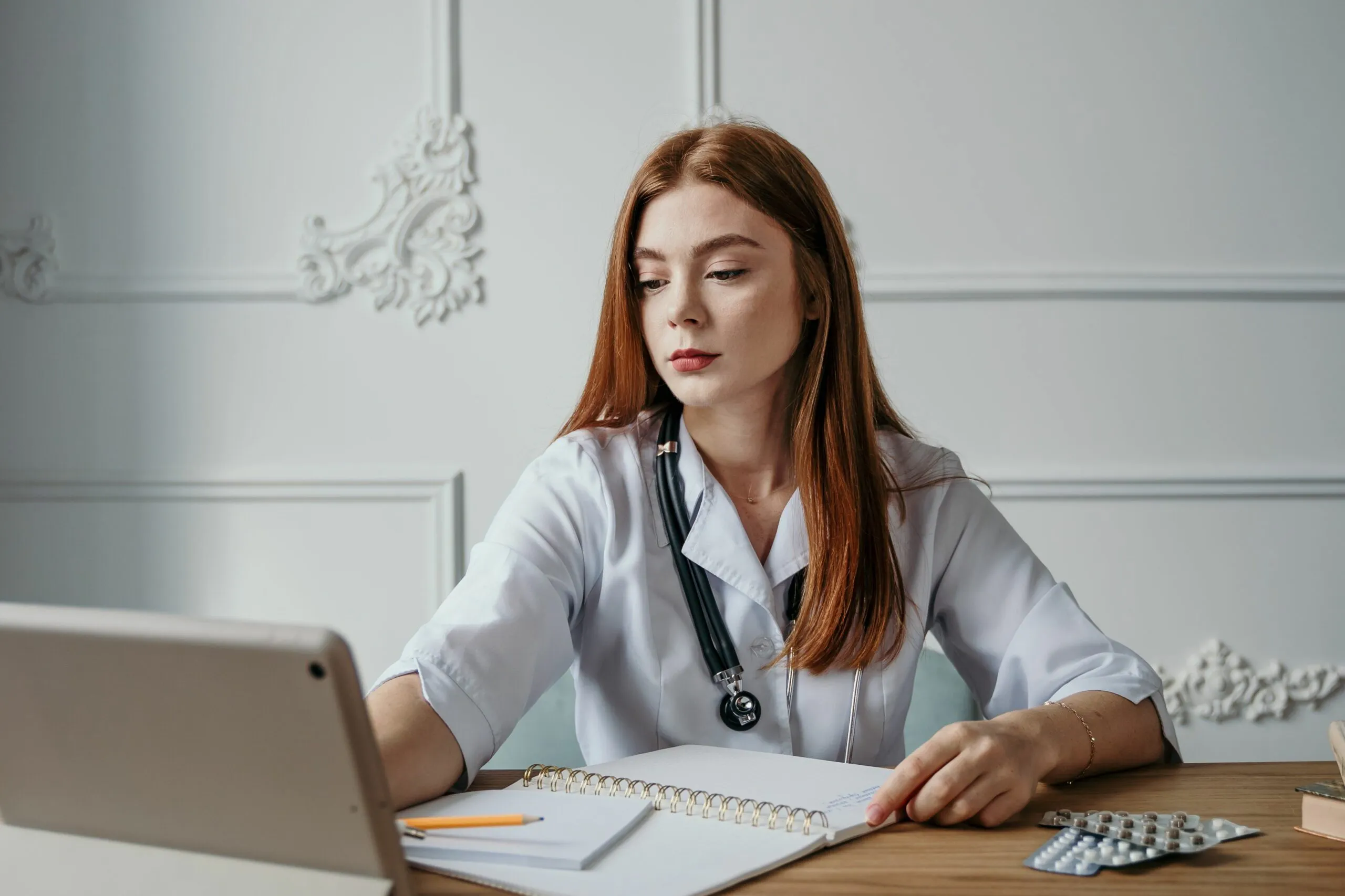 Physician managing patient care at a computer, similar to Step 3 case simulations