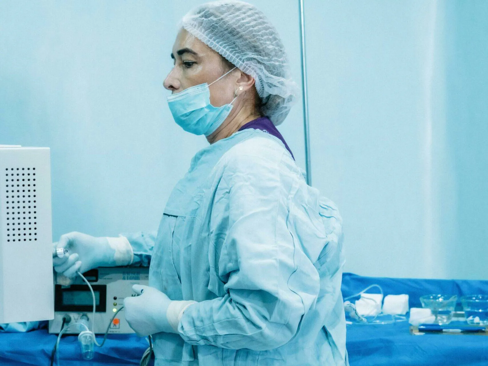 Nurse carefully preparing medical equipment for patient care