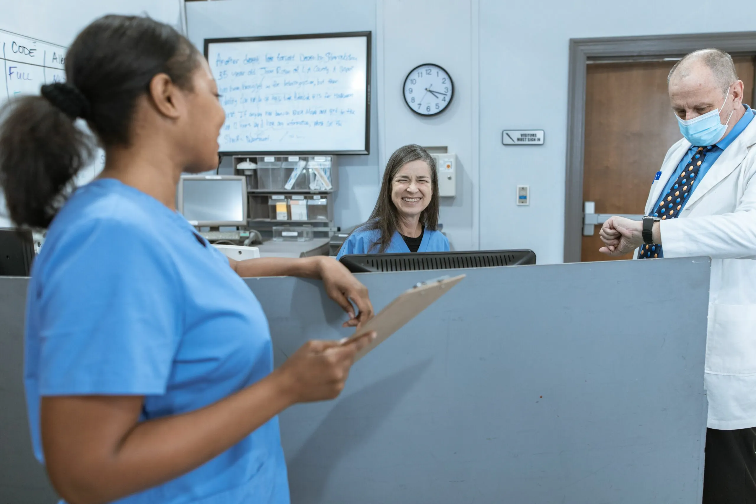 nurses working together and discussing patient care in a hospital